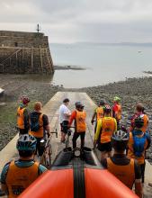 GCHQ Bude cycling event riders at the start at Clovelly RNLI station