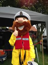 RNLI mascot Stormy Stan giving a thumbs up